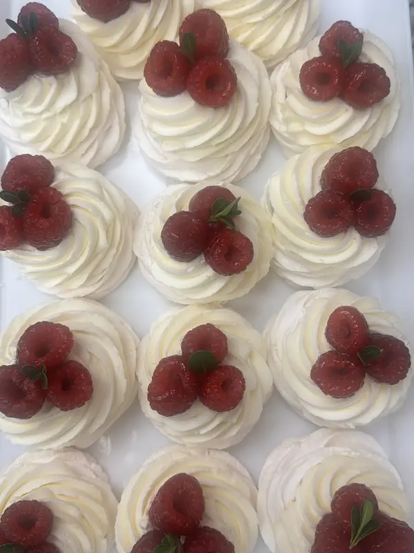 Meringue nests with whipped cream and raspberries